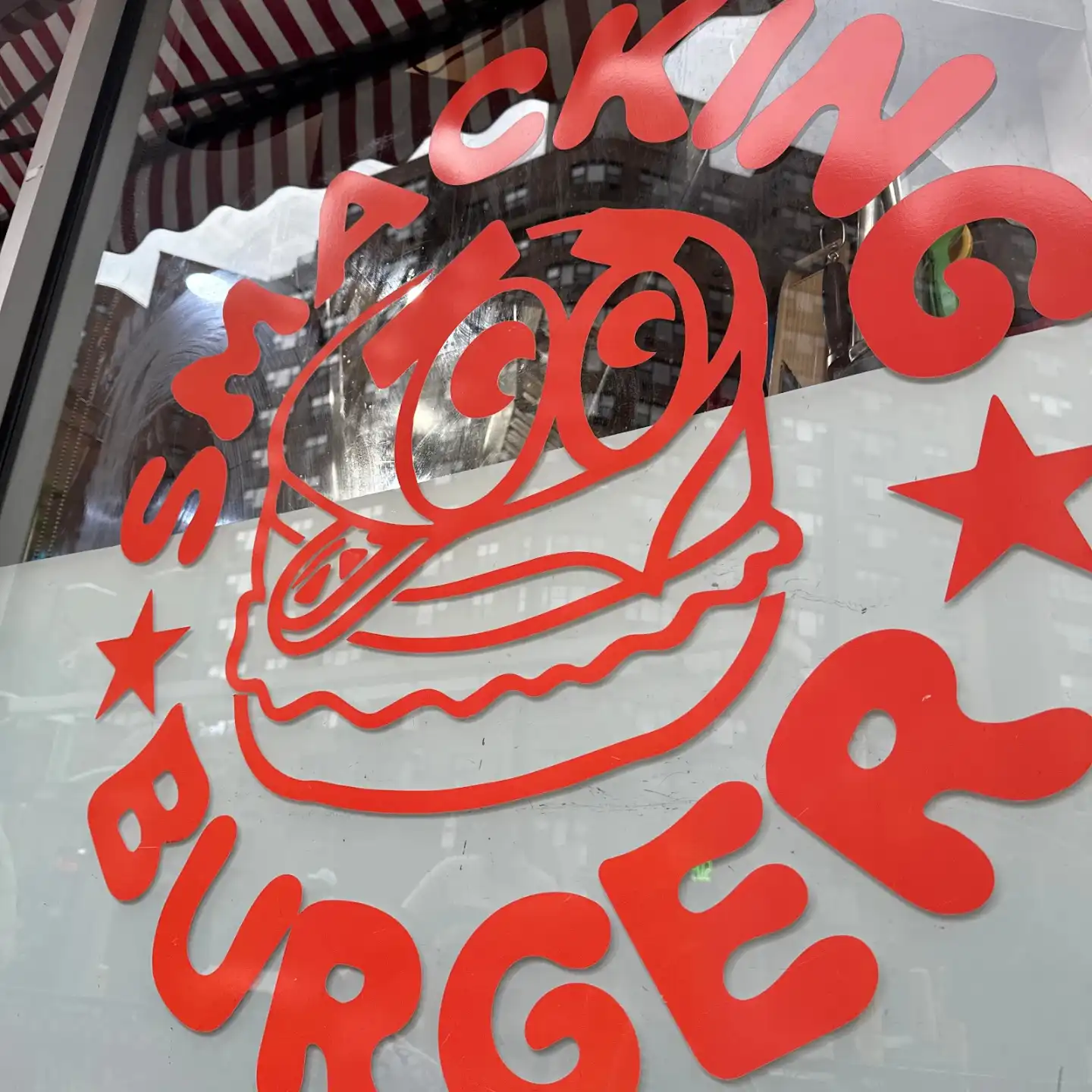 Freshly prepared smash burger at Smacking Burger West Village.